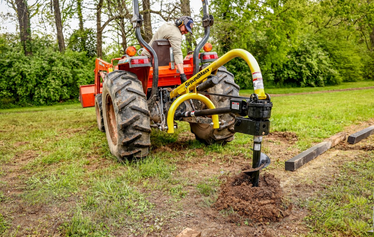 GroundMaxx PHD18 post hole digger boring a fence-post hole next to landscape timbers -- auger sold separately